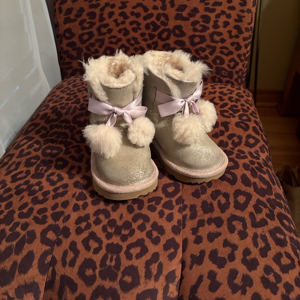 UGG kids’ Gita Metalic Pom Pom in pale shimmery pink